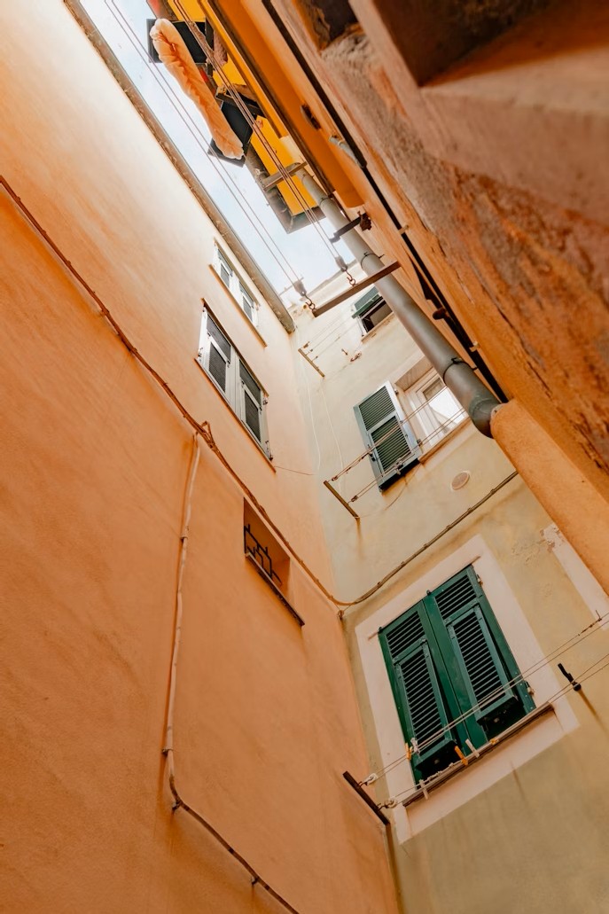 Narrow alley and sky, symbolising feeling boxed in and torn